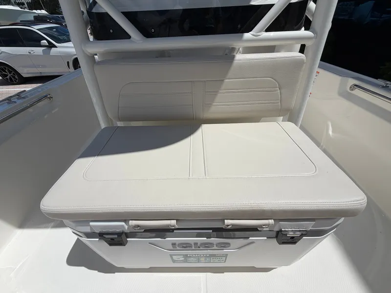Slide: The Image of The 2027 Boston Whaler 210 Montauk features a cushioned bench seat with integrated storage. - 30