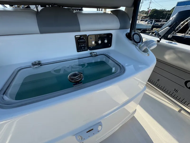 Slide: The Image of 2022 NauticStar 2602 Legacy with control panel and gauges. - 13