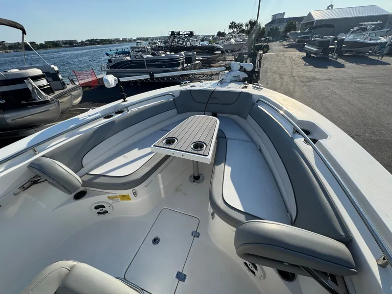 Slide: The Image of NauticStar 2602 Legacy 2022 on a boat deck by the water. - 27