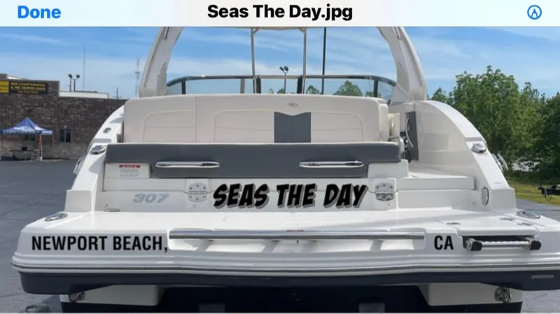 Slide: The Image of Rear view of a 2017 Chaparral 307 SSX boat with "Seas The Day" lettering. - 11