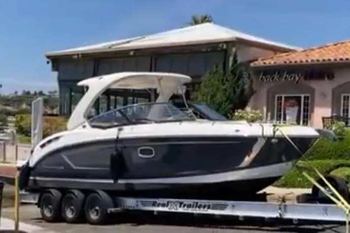 Slide: The Image of 2017 Chaparral 307 SSX boat on trailer in front of building. - 18