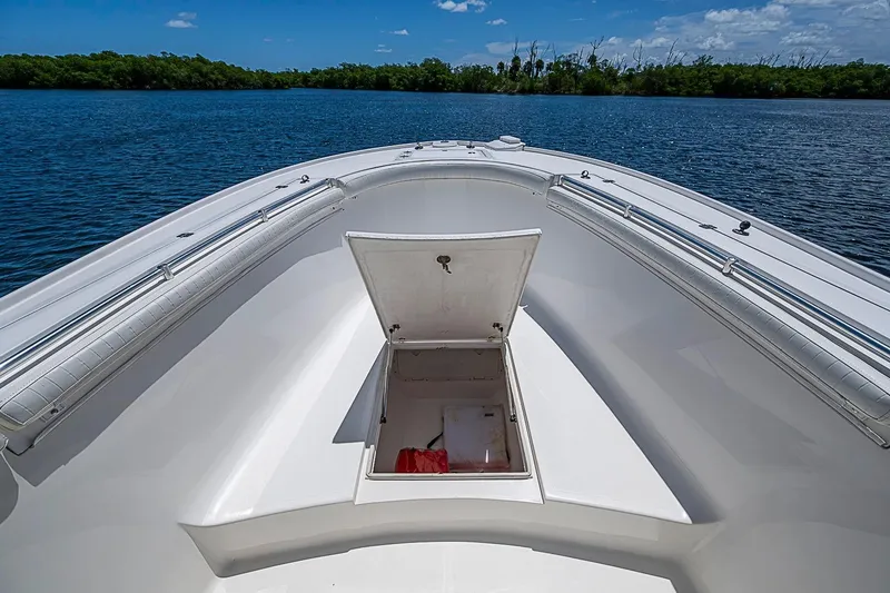 Slide: The Image of 2008 Buddy Davis 34 Center Console boat with open storage compartment on calm water. - 11
