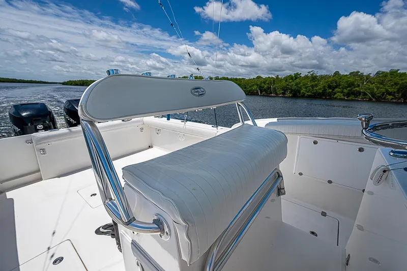 Slide: The Image of 2008 Buddy Davis 34 Center Console boat with white seating, on a calm waterway. - 14