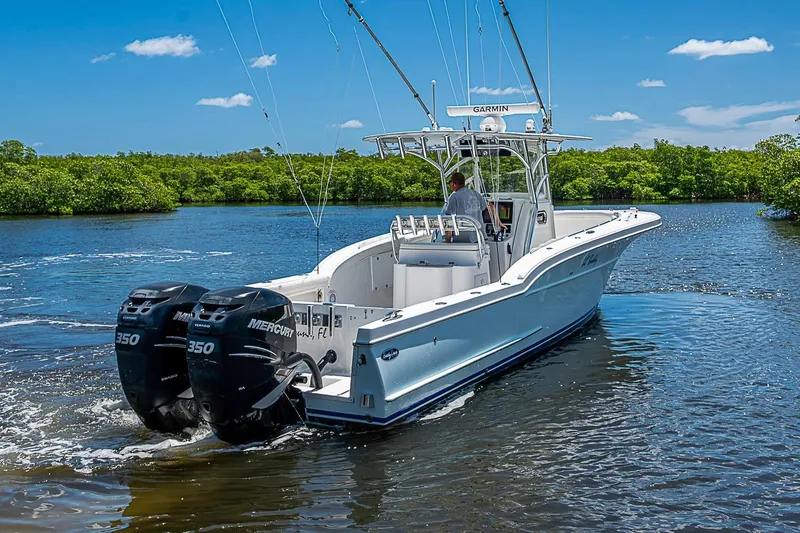 Slide: The Image of 2008 Buddy Davis 34 Center Console boat cruising on a sunny day with twin Mercury engines. - 15