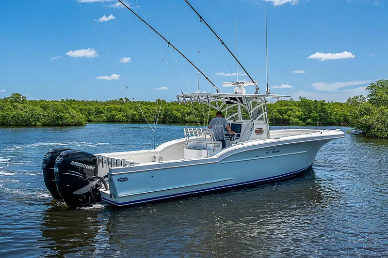 Slide: The Image of 2008 Buddy Davis 34 Center Console boat on a sunny day, cruising on calm waters. - 18