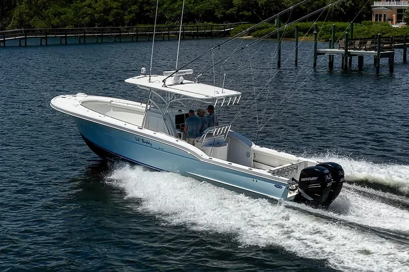 Slide: The Image of 2008 Buddy Davis 34 Center Console boat cruising on water with twin Mercury engines. - 22