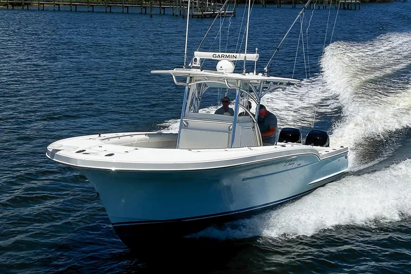 Slide: The Image of 2008 Buddy Davis 34 Center Console boat cruising on water with two passengers. - 23
