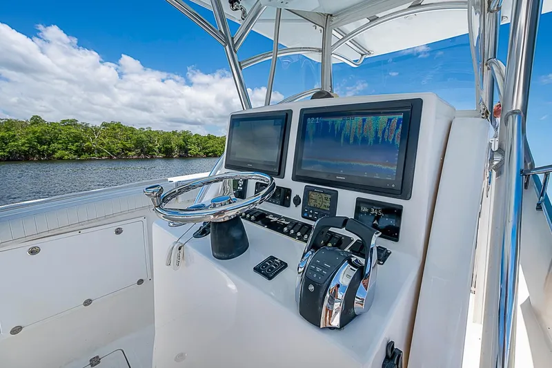 Slide: The Image of 2008 Buddy Davis 34 Center Console boat dashboard with dual screens and controls. - 3