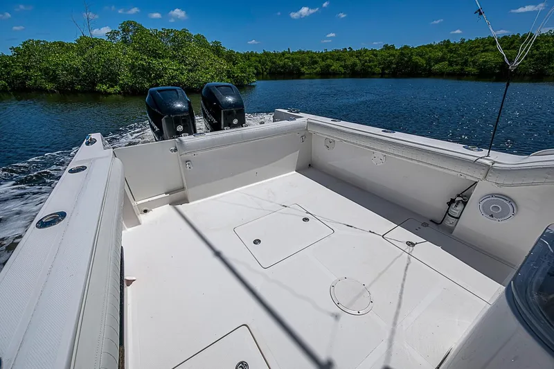 Slide: The Image of 2008 Buddy Davis 34 Center Console boat with dual engines on a serene waterway. - 8