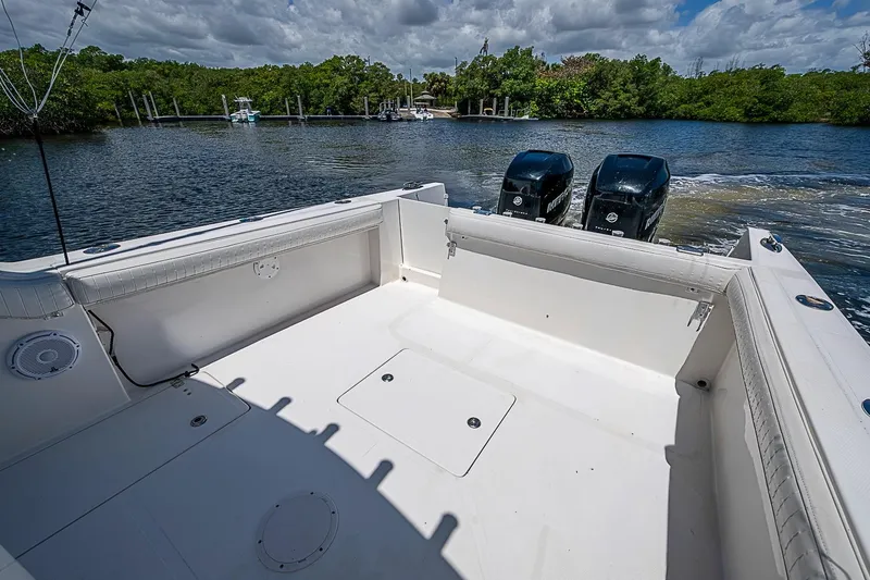 Slide: The Image of 2008 Buddy Davis 34 Center Console boat with twin engines on a calm waterway. - 9