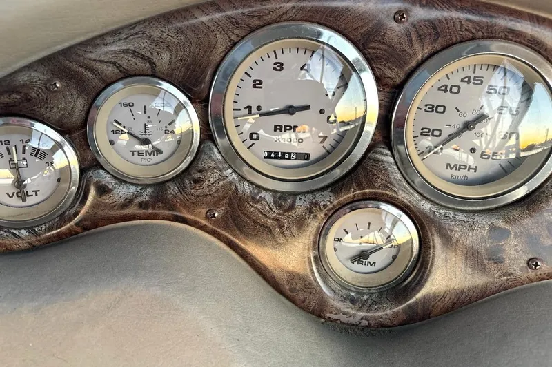 Slide: The Image of Dashboard gauges of a 2001 Stingray 240 CS boat, featuring RPM, speed, and temperature indicators. - 4