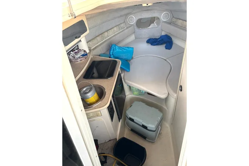 Slide: The Image of 2001 Stingray 240 CS cabin interior with kitchenette and seating area. - 6
