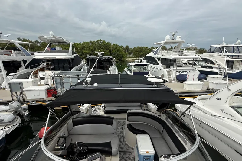 Slide: The Image of 2003 Rinker Fiesta Vee 342 docked among luxury yachts at a marina. - 10