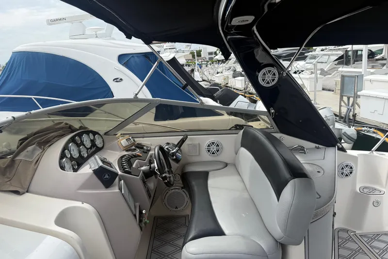 Slide: The Image of 2003 Rinker Fiesta Vee 342 boat interior with steering wheel and dashboard controls. - 11