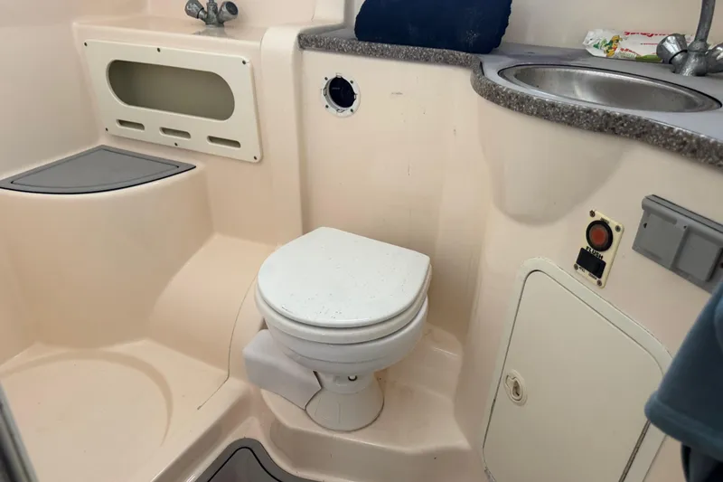 Slide: The Image of 2003 Rinker Fiesta Vee 342 boat bathroom with toilet, sink, and storage compartments. - 15