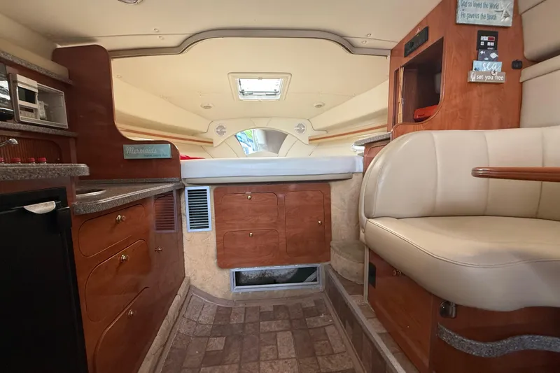 Slide: The Image of 2003 Rinker Fiesta Vee 342 cabin interior with kitchenette and seating area. - 16