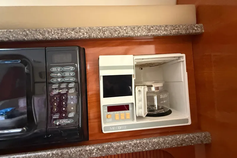 Slide: The Image of Microwave and coffee maker in 2003 Rinker Fiesta Vee 342 boat kitchen. - 19
