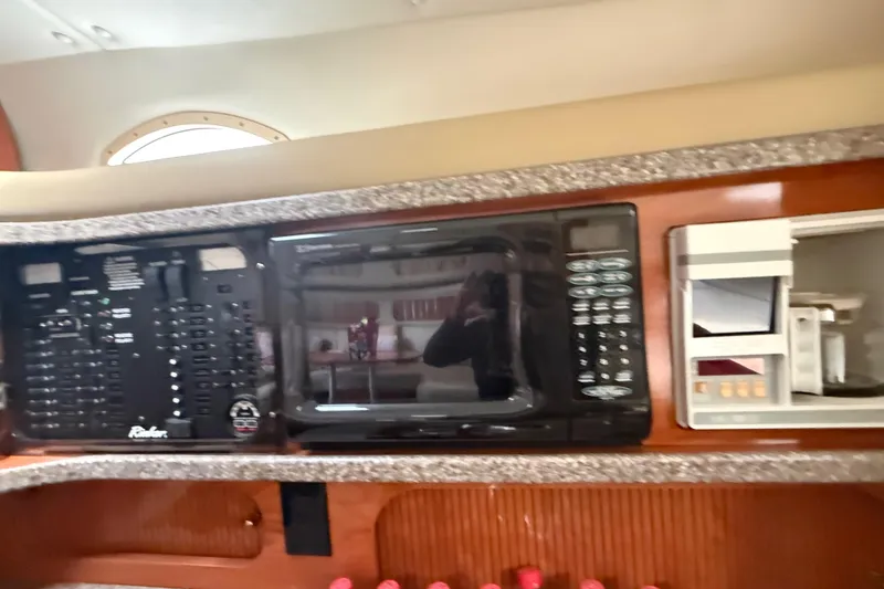 Slide: The Image of 2003 Rinker Fiesta Vee 342 interior with control panel and microwave. - 20