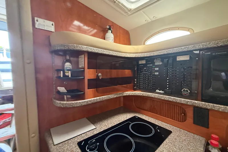 Slide: The Image of 2003 Rinker Fiesta Vee 342 interior with control panel and kitchenette. - 22