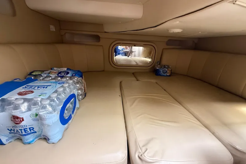 Slide: The Image of Interior of 2003 Rinker Fiesta Vee 342 cabin with water bottles on beige seating. - 23