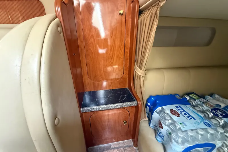 Slide: The Image of Interior of 2003 Rinker Fiesta Vee 342 with wood cabinet and bottled water storage. - 24