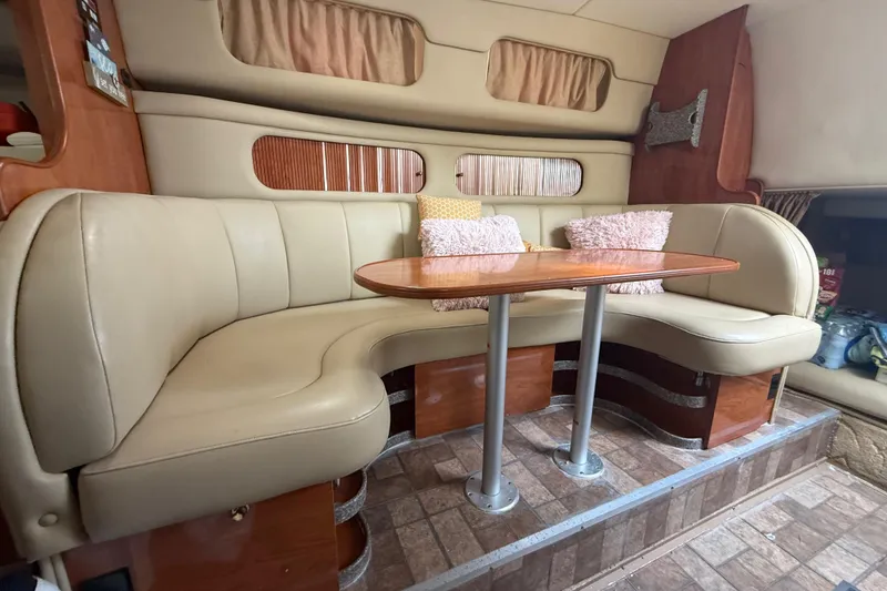 Slide: The Image of Interior of 2003 Rinker Fiesta Vee 342 with beige seating and wooden table. - 25