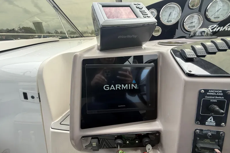 Slide: The Image of 2003 Rinker Fiesta Vee 342 dashboard with Garmin navigation system and control panel. - 28
