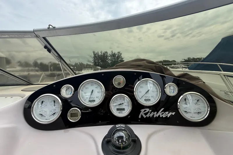 Slide: The Image of Dashboard of a 2003 Rinker Fiesta Vee 342 boat with gauges and compass. - 29