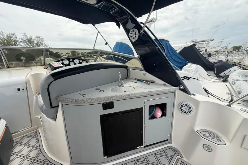Slide: The Image of 2003 Rinker Fiesta Vee 342 boat interior with helm, seating, and storage compartments. - 3