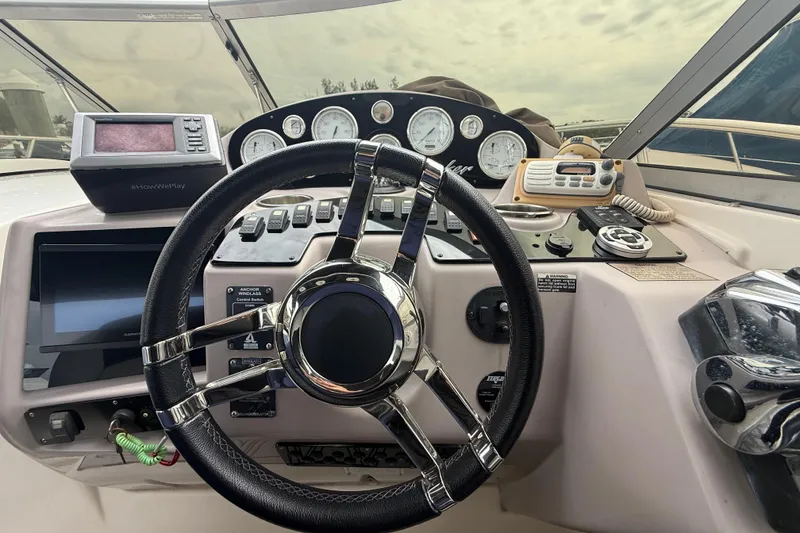 Slide: The Image of Steering wheel and dashboard of 2003 Rinker Fiesta Vee 342 boat cockpit. - 31