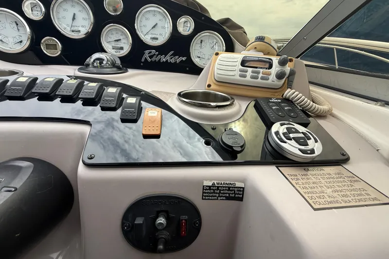 Slide: The Image of Control panel of a 2003 Rinker Fiesta Vee 342 boat with gauges and radio. - 32