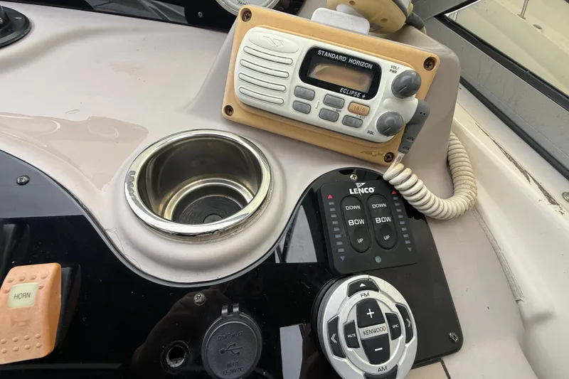Slide: The Image of Control panel of a 2003 Rinker Fiesta Vee 342 boat with radio and cup holder. - 33