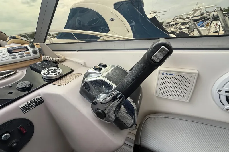 Slide: The Image of Control panel of a 2003 Rinker Fiesta Vee 342 boat with throttle and radio. - 34