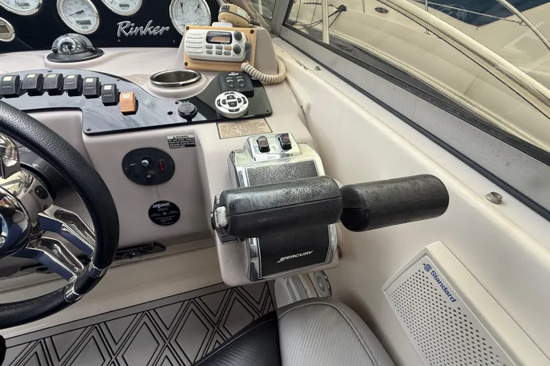 Slide: The Image of Helm controls of a 2003 Rinker Fiesta Vee 342 boat, featuring Mercury throttle and gauges. - 35