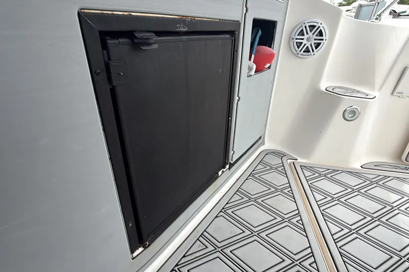 Slide: The Image of 2003 Rinker Fiesta Vee 342 boat interior with storage compartment and speaker. - 39