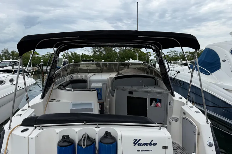 Slide: The Image of 2003 Rinker Fiesta Vee 342 boat docked, featuring spacious cockpit and canopy. - 43