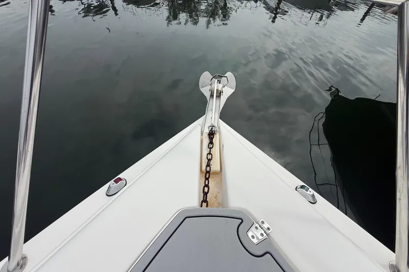 Slide: The Image of Bow view of 2003 Rinker Fiesta Vee 342 boat with anchor chain on calm water. - 46