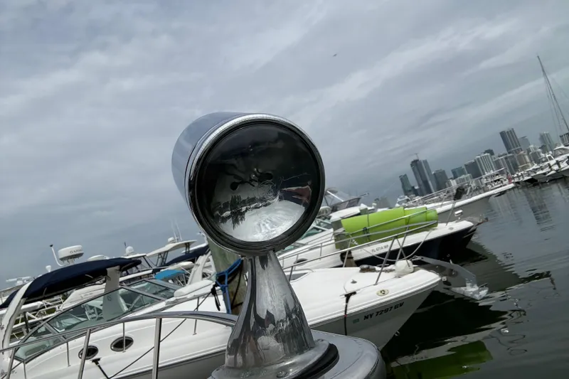 Slide: The Image of 2003 Rinker Fiesta Vee 342 spotlight with marina and city skyline in the background. - 47