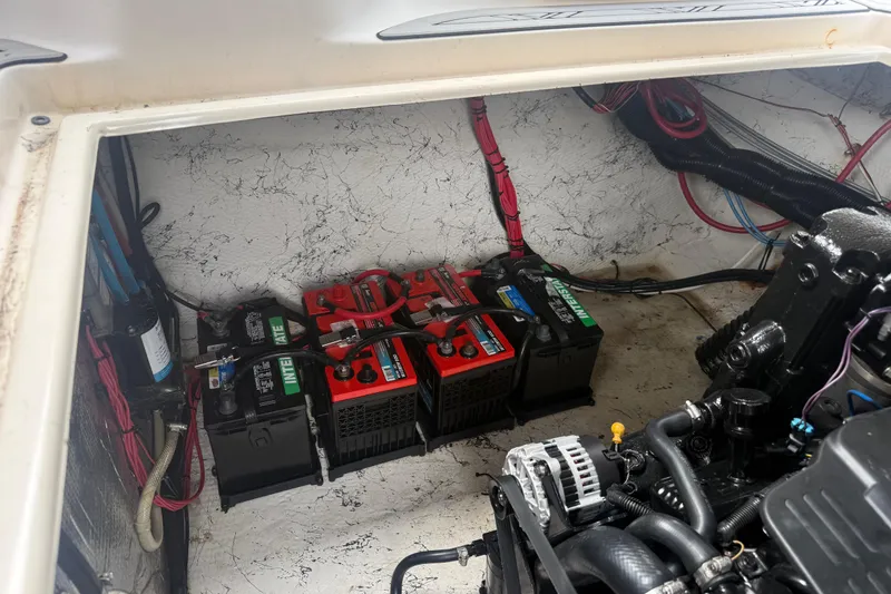 Slide: The Image of Engine compartment of a 2003 Rinker Fiesta Vee 342 with multiple marine batteries. - 49