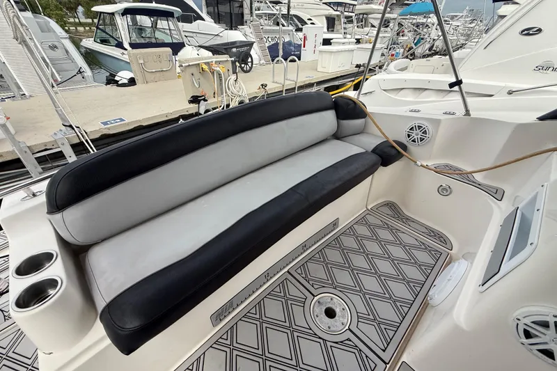 Slide: The Image of 2003 Rinker Fiesta Vee 342 boat interior with cushioned seating and patterned flooring. - 5