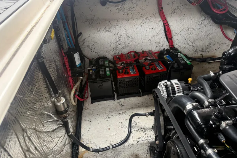Slide: The Image of Engine compartment of a 2003 Rinker Fiesta Vee 342 with batteries and wiring. - 50