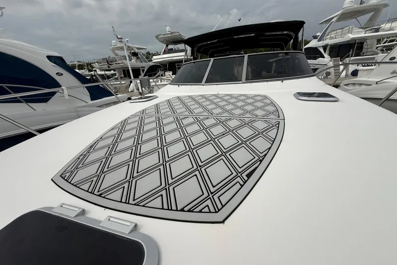 Slide: The Image of 2003 Rinker Fiesta Vee 342 yacht with patterned deck, docked among other boats. - 53