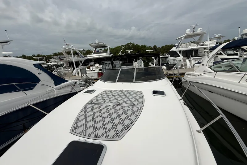 Slide: The Image of 2003 Rinker Fiesta Vee 342 yacht docked among other boats in a marina. - 54