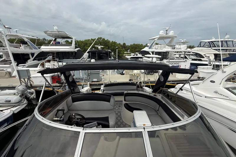Slide: The Image of 2003 Rinker Fiesta Vee 342 yacht docked at marina, surrounded by other boats. - 55