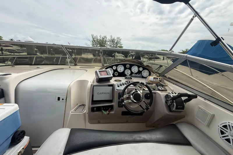 Slide: The Image of 2003 Rinker Fiesta Vee 342 boat cockpit with steering wheel and Garmin navigation system. - 6