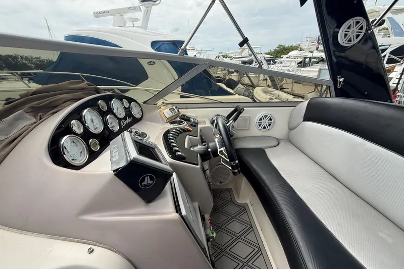 Slide: The Image of 2003 Rinker Fiesta Vee 342 boat cockpit with steering wheel and instrument panel. - 7
