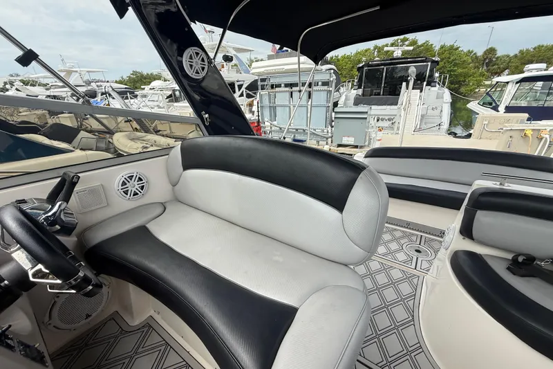 Slide: The Image of 2003 Rinker Fiesta Vee 342 boat interior with black and white seating at marina. - 8