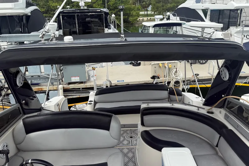 Slide: The Image of 2003 Rinker Fiesta Vee 342 boat interior with seating and canopy at marina. - 9