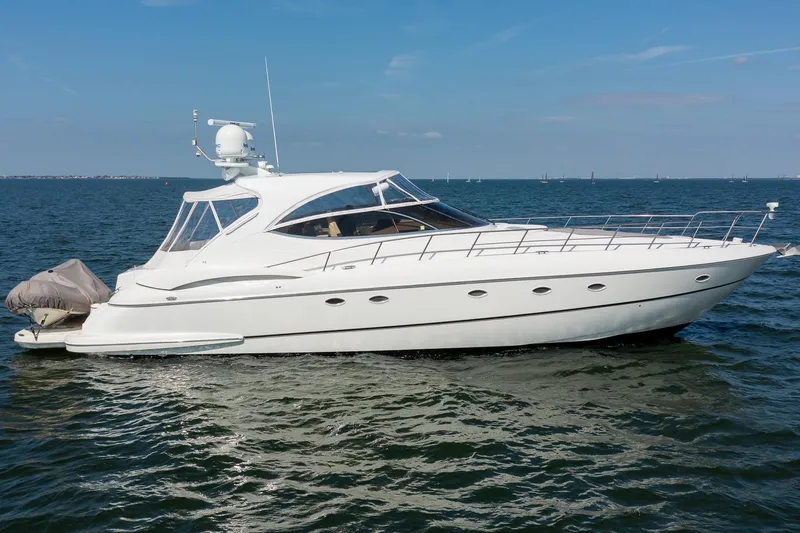 The Image of 2002 Cruisers 5370 yacht on open water, sleek design, clear sky background. - 0