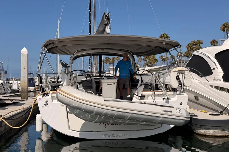 Slide: The Image of 2020 Beneteau Oceanis 46.1 yacht docked at marina with inflatable boat attached. - 101